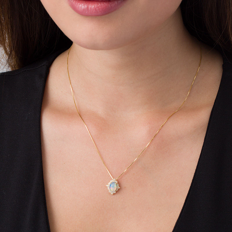 Main Image 2 of Oval Opal and 1/15 CT. T.W. Diamond Vintage-Style Frame Pendant in 10K Gold