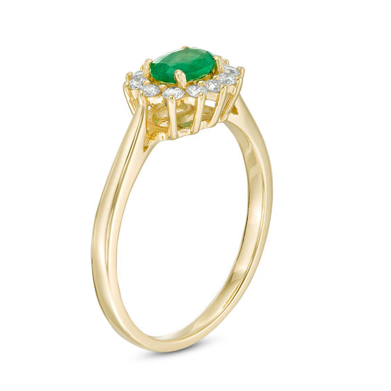 Oval Emerald and 1/5 CT. T.w. Diamond Starburst Frame Ring in 10K Gold