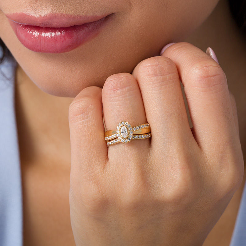 3/4 CT. T.W. Oval Diamond Frame Crossover Bridal Set in 14K Gold