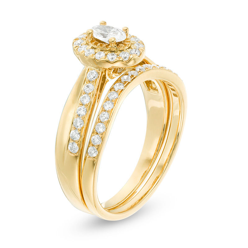 3/4 CT. T.W. Oval Diamond Frame Crossover Bridal Set in 14K Gold