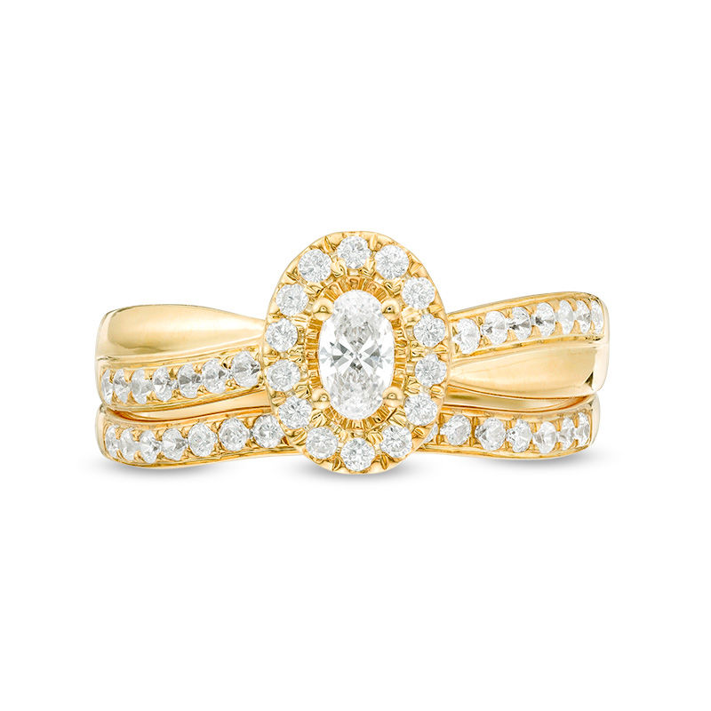 3/4 CT. T.W. Oval Diamond Frame Crossover Bridal Set in 14K Gold