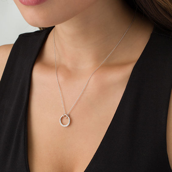 1/20 CT. T.w. Diamond Open Circle Heart Knot Pendant in Sterling Silver and 10K Rose Gold