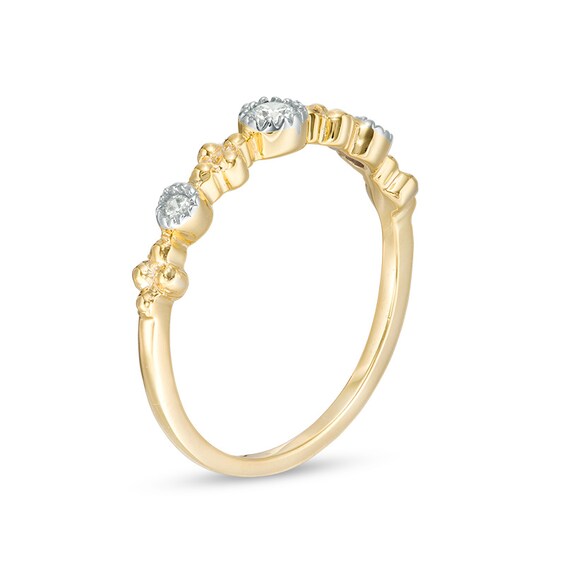 1/15 CT. T.w. Diamond Three Stone Beaded Band in 10K Gold