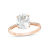 Thumbnail Image 0 of Oval Lab-Created White Sapphire and 1/20 CT. T.W. Diamond Ring in 10K Rose Gold - Size 7