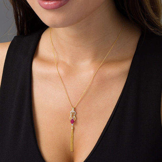 Oval Lab-Created Ruby and 1/20 CT. T.W. Diamond Double Loop Knot Tassel Pendant in Sterling Silver with 14K Gold Plate Oval Lab-Created Ruby and 1/20 CT. T.W. Diamond Double Loop Knot Tassel Pendant in Sterling Silver with 14K Gold Plate