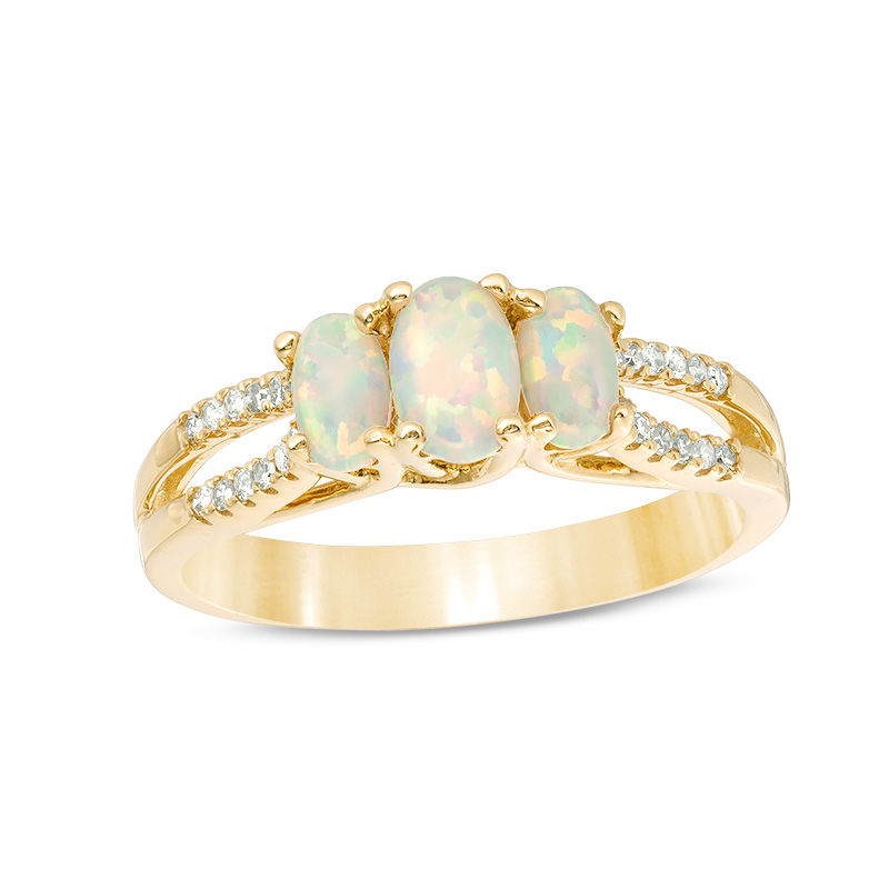 Oval Lab-Created Opal and 1/10 CT. T.W. Diamond Three Stone Ring in 10K ...