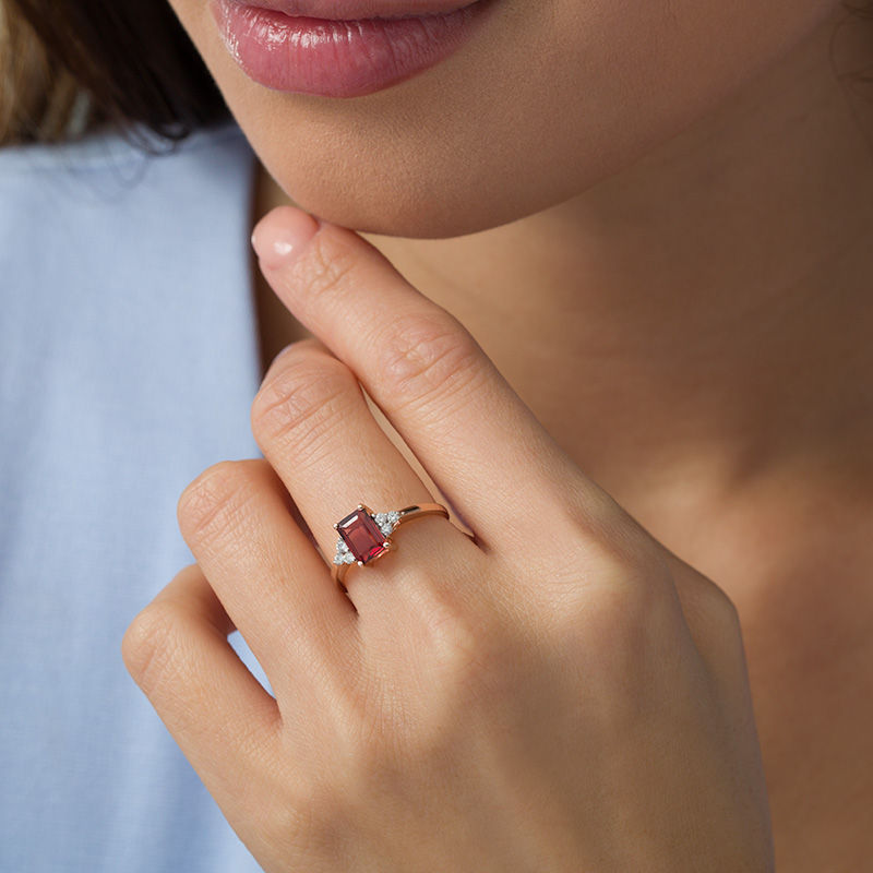 Emerald-Cut Garnet and 1/8 CT. T.W. Diamond Tri-Sides Engagement Ring in 10K Rose Gold