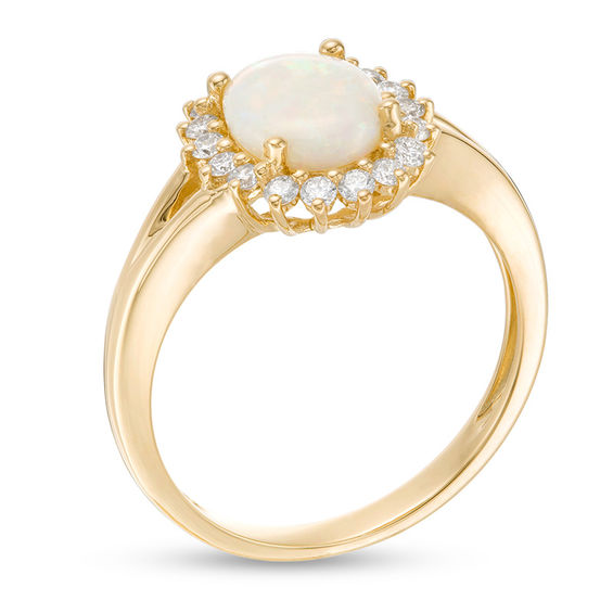 Oval Opal and 1/3 CT. T.w. Diamond Sunburst Frame Ring in 14K Gold