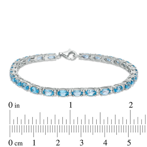 Oval Blue Topaz and Lab-Created White Sapphire Line Bracelet in Sterling Silver