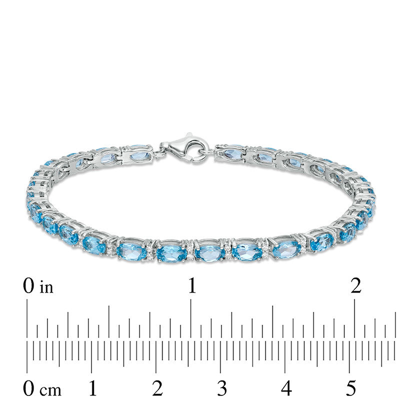 Oval Blue Topaz and Lab-Created White Sapphire Line Bracelet in Sterling Silver