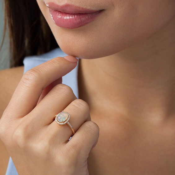 Oval Opal and 1/6 CT. T.w. Diamond Frame Ring in 14K Rose Gold