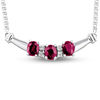 Thumbnail Image 0 of Oval Ruby and 1/15 CT. T.W. Diamond Three Stone Curved Bar Necklace in 14K White Gold - 17.25"