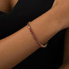 Thumbnail Image 1 of Garnet Tennis Bracelet in Sterling Silver with 14K Gold Plate - 7.25"