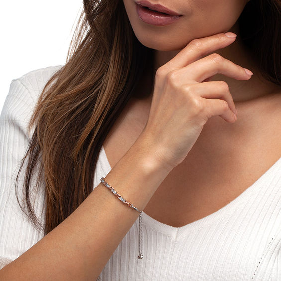 1/15 CT. T.W. Diamond Layered "XO" Bolo Bracelet in Sterling Silver and 10K Rose Gold - 9.5" 1/15 CT. T.W. Diamond Layered "XO" Bolo Bracelet in Sterling Silver and 10K Rose Gold - 9.5"