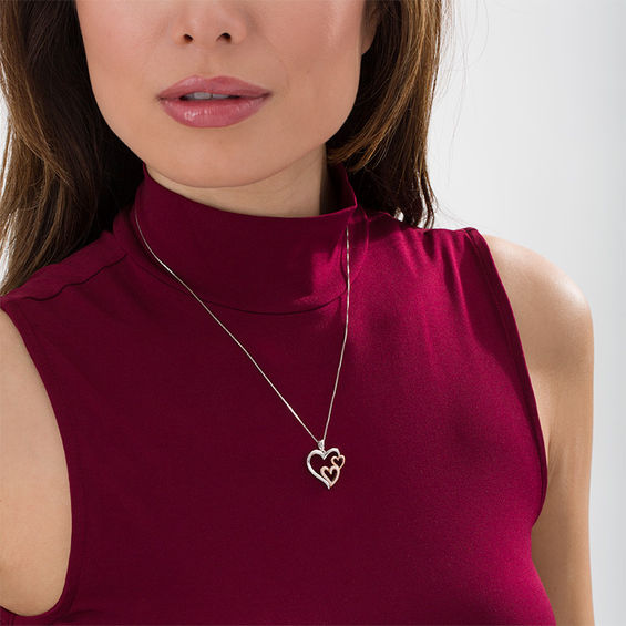 1/8 CT. T.w. Diamond Triple Heart Pendant in Sterling Silver and 10K Rose Gold