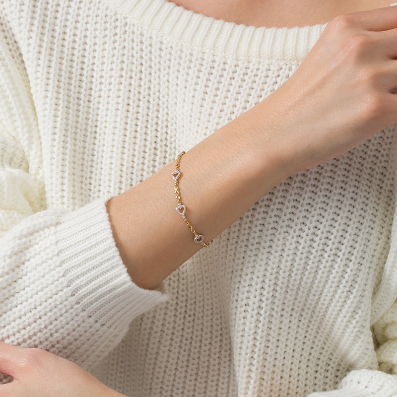 Main Image 2 of 1/10 CT. T.W. Diamond sideways Heart Station Twist Bracelet in 10K Gold - 7.5"