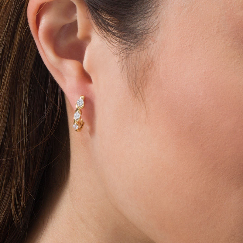Main Image 2 of 1/2 CT. T.W. Diamond Three Stone "XO" Twist Hoop Earrings in 10K Gold