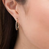 Thumbnail Image 2 of 1/10 CT. T.W. Diamond Twist Oval Hoop Earrings in 10K Gold