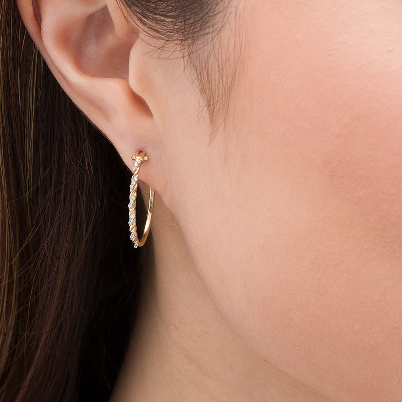 Main Image 2 of 1/10 CT. T.W. Diamond Twist Oval Hoop Earrings in 10K Gold
