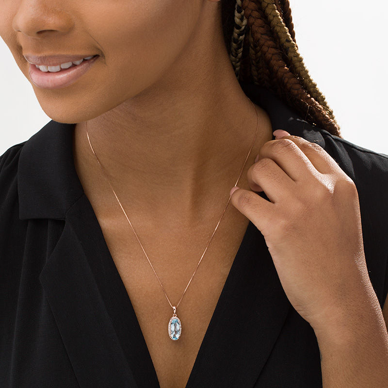 Main Image 2 of Elongated Oval Sky Blue Topaz and 1/6 CT. T. Diamond Frame Drop Pendant in 10K Rose Gold