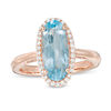 Thumbnail Image 1 of Elongated Oval Sky Blue Topaz and 1/6 CT. T.W. Diamond Frame Ring in 10K Rose Gold