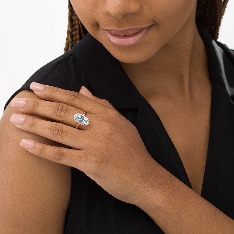 Main Image 2 of Elongated Oval Sky Blue Topaz and 1/6 CT. T.W. Diamond Frame Ring in 10K Rose Gold