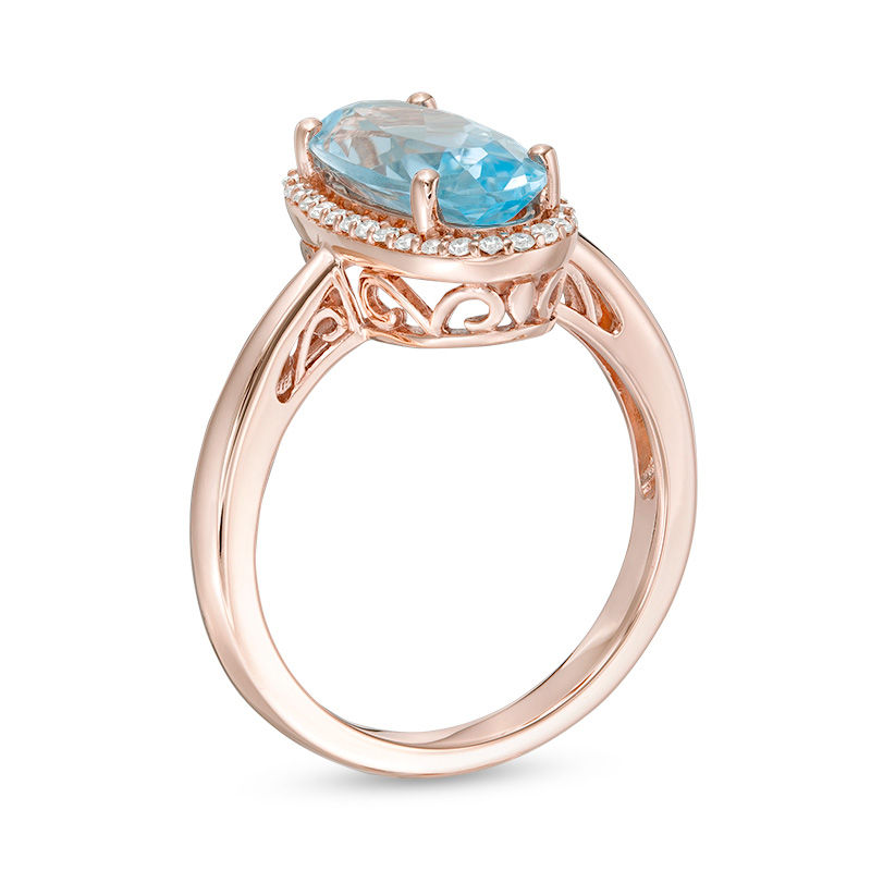 Main Image 3 of Elongated Oval Sky Blue Topaz and 1/6 CT. T.W. Diamond Frame Ring in 10K Rose Gold