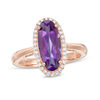 Thumbnail Image 0 of Elongated Oval Amethyst and 1/6 CT. T.W. Diamond Frame Ring in 10K Rose Gold