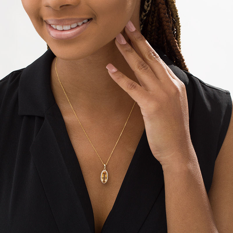 Main Image 2 of Elongated Oval Citrine and 1/6 CT. T.W. Diamond Frame Drop Pendant in 10K Gold