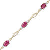 Thumbnail Image 1 of Oval Ruby and Diamond Accent Station Bracelet in 10K Gold - 7.5"