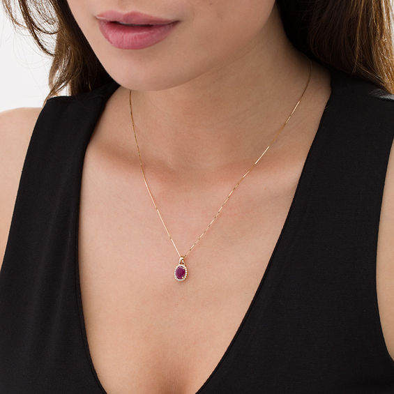 Oval Ruby and 1/10 CT. T.w. Diamond Frame Pendant in 10K Gold