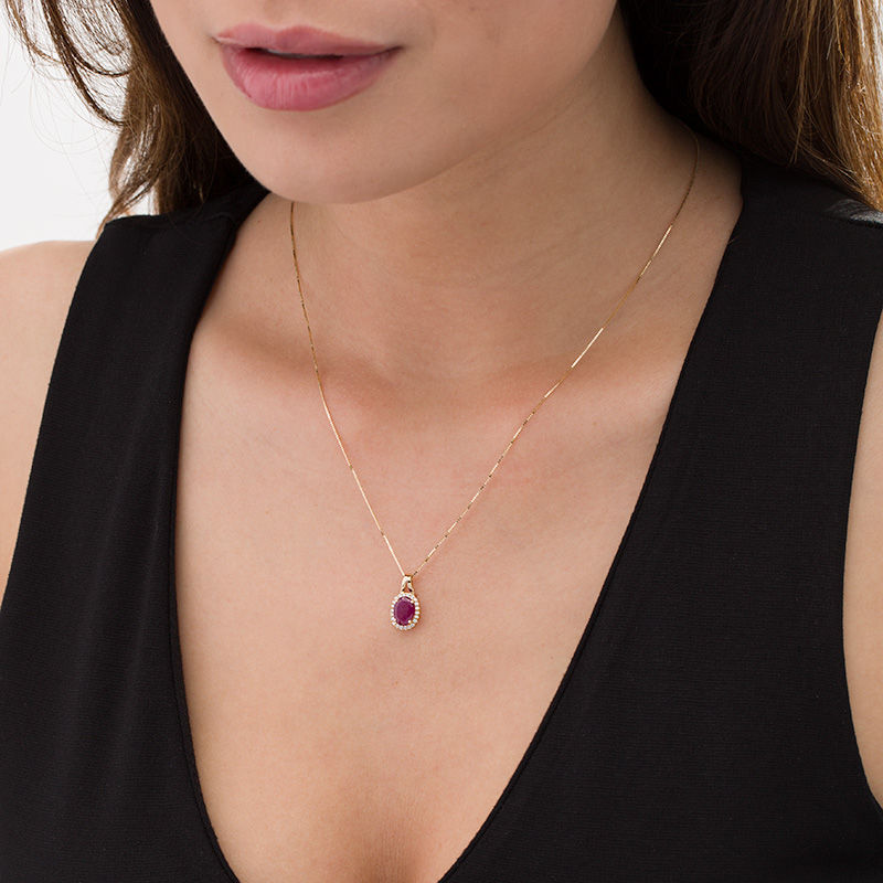 Main Image 2 of Oval Ruby and 1/10 CT. T.W. Diamond Frame Pendant in 10K Gold