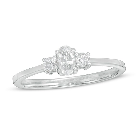 1/2 CT. T.w. Oval and Round Diamond Three Stone Engagement Ring in 14K Gold