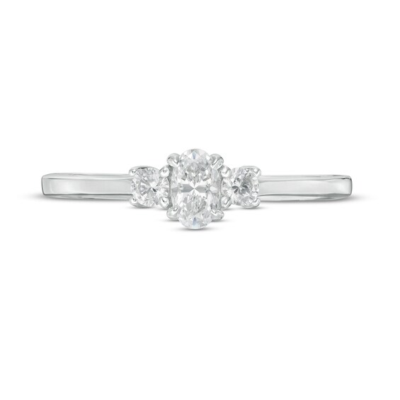 1/2 CT. T.w. Oval and Round Diamond Three Stone Engagement Ring in 14K Gold