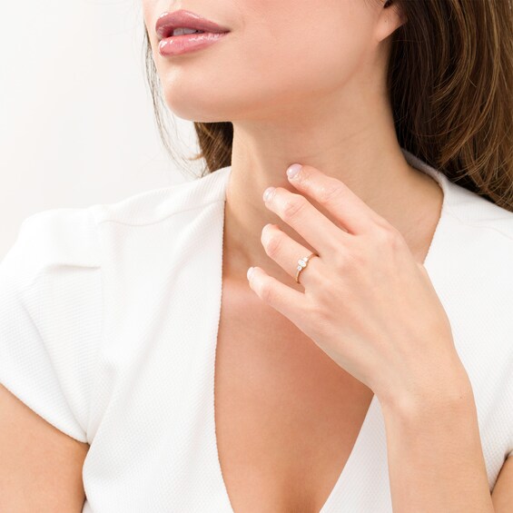 1/2 CT. T.w. Oval and Round Diamond Three Stone Engagement Ring in 14K Gold