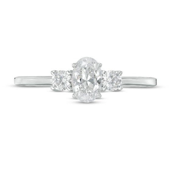 CT. T.w. Oval and Round Diamond Three Stone Engagement Ring in 14K Gold
