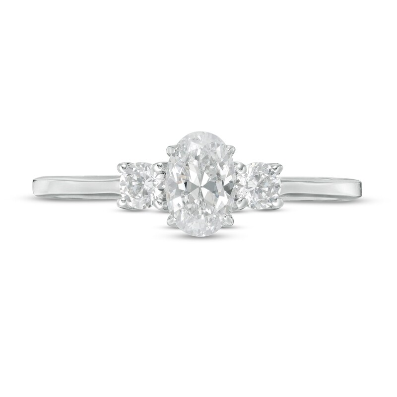 5/8 CT. T.W. Oval and Round Diamond Three Stone Engagement Ring in 14K White Gold