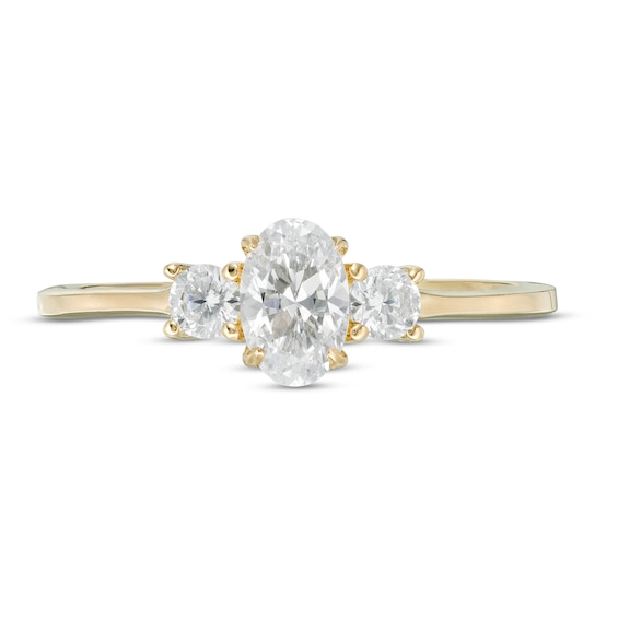 5/8 CT. T.w. Oval and Round Diamond Three Stone Engagement Ring in 14K Gold