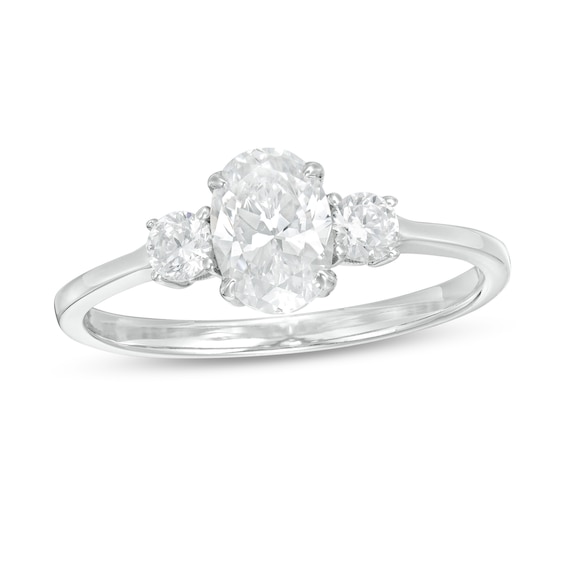 1 CT. T.w. Oval and Round Diamond Three Stone Engagement Ring in 14K White Gold