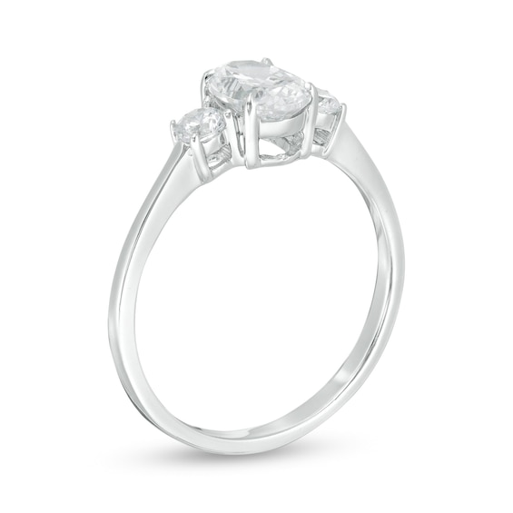 1 CT. T.w. Oval and Round Diamond Three Stone Engagement Ring in 14K White Gold