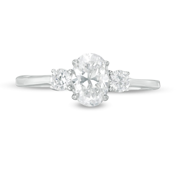1 CT. T.w. Oval and Round Diamond Three Stone Engagement Ring in 14K White Gold