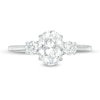 1-1/4 CT. T.W. Oval and Round Diamond Three Stone Engagement Ring in 14K White Gold