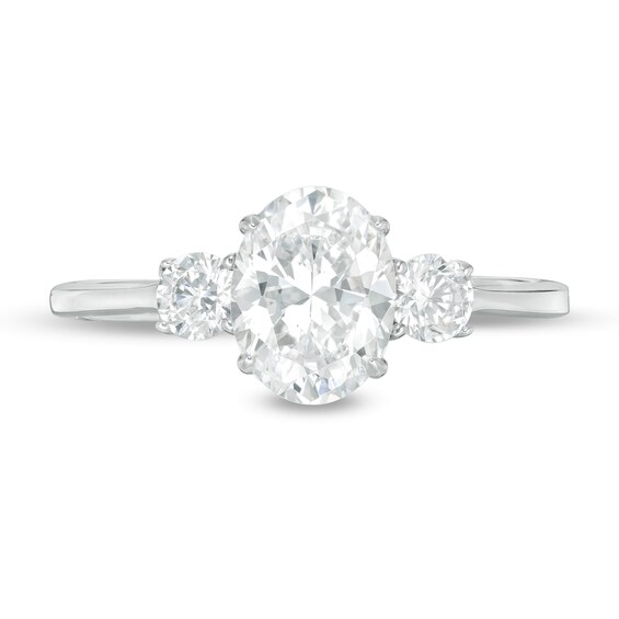 1-1/4 CT. T.w. Oval and Round Diamond Three Stone Engagement Ring in 14K White Gold