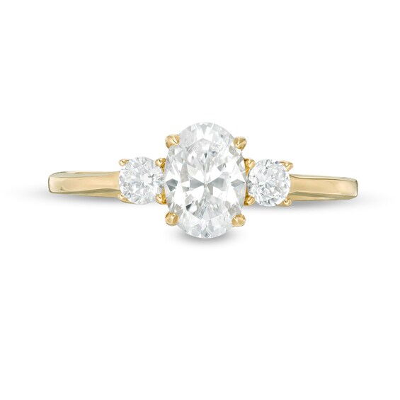 1 CT. T.w. Oval and Round Diamond Three Stone Engagement Ring in 14K Gold