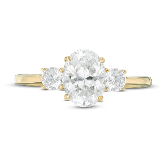 1-1/4 CT. T.w. Oval and Round Diamond Three Stone Engagement Ring in 14K Gold