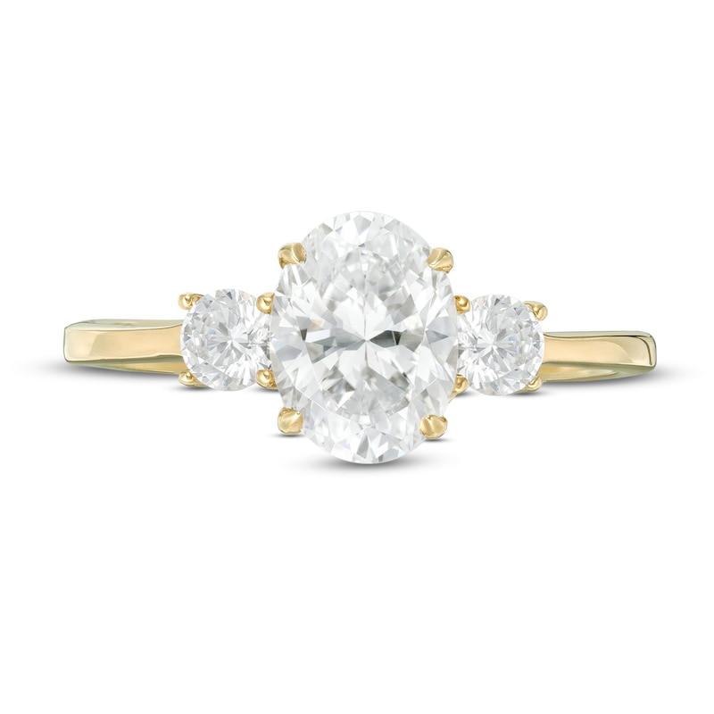 1-1/4 CT. T.W. Oval and Round Diamond Three Stone Engagement Ring in 14K Gold