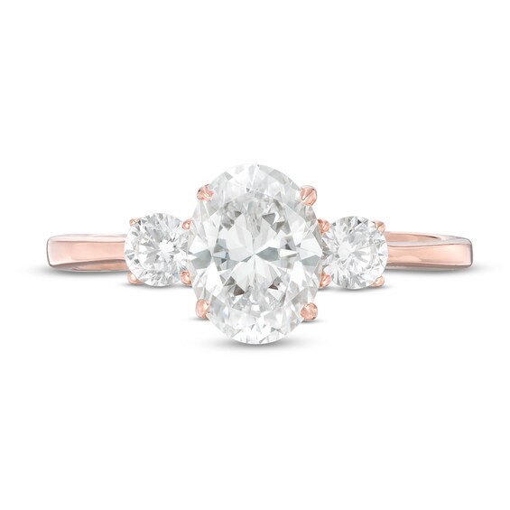 1-1/4 CT. T.w. Oval and Round Diamond Three Stone Engagement Ring in 14K Rose Gold