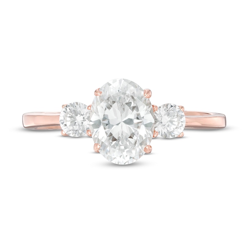 1-1/4 CT. T.W. Oval and Round Diamond Three Stone Engagement Ring in 14K Rose Gold