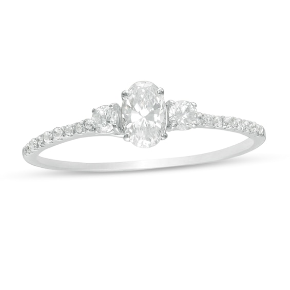 5/8 CT. T.w. Oval and Round Diamond Three Stone Engagement Ring in 14K White Gold