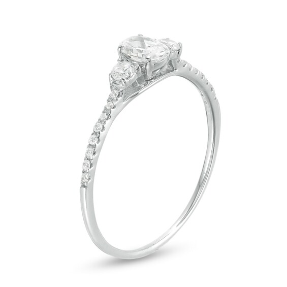 5/8 CT. T.w. Oval and Round Diamond Three Stone Engagement Ring in 14K White Gold
